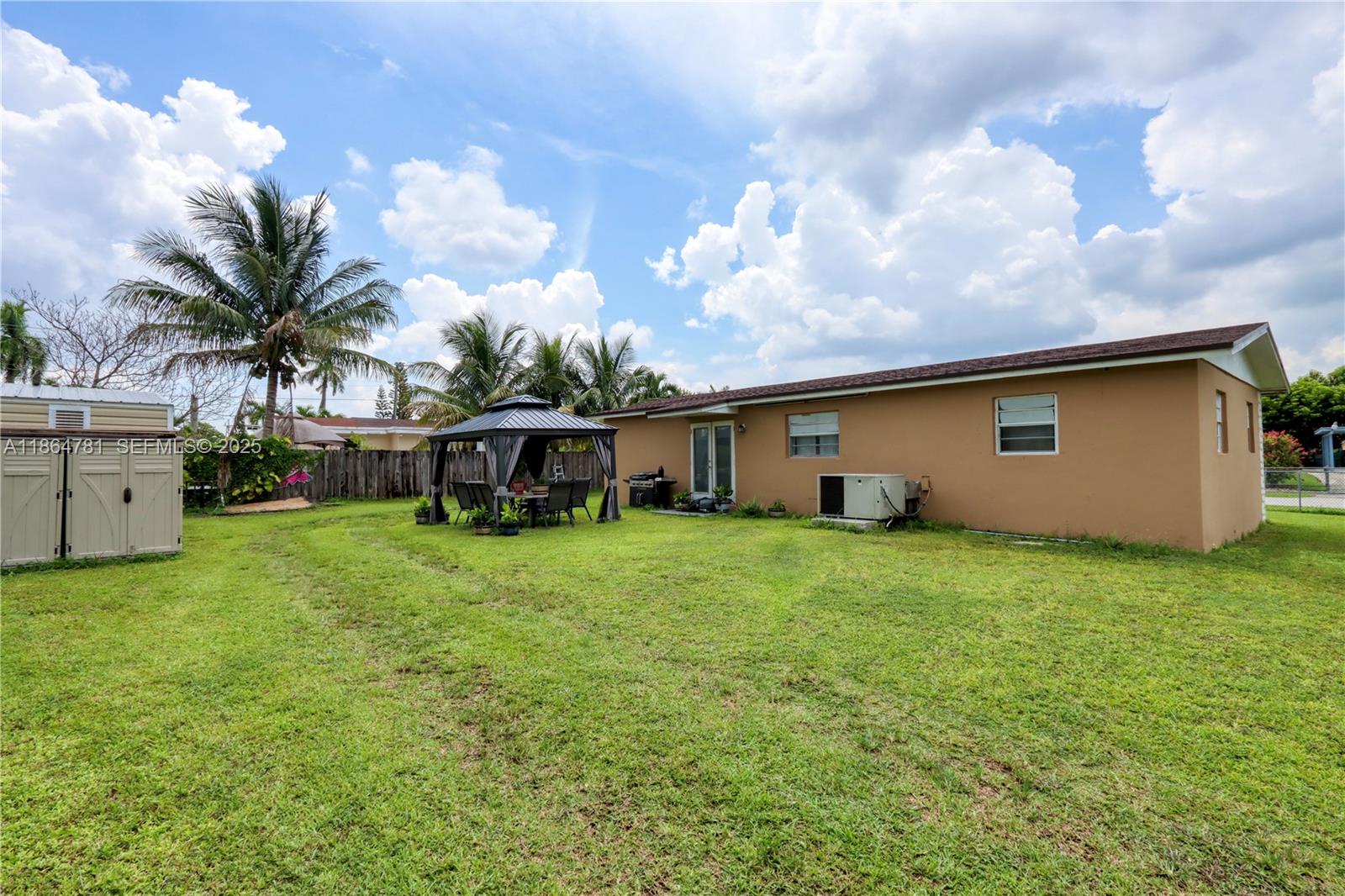 30211 Southwest 158th Road Homestead, FL 33033 - Photo 11 of 47 a front view of house with yard and trees