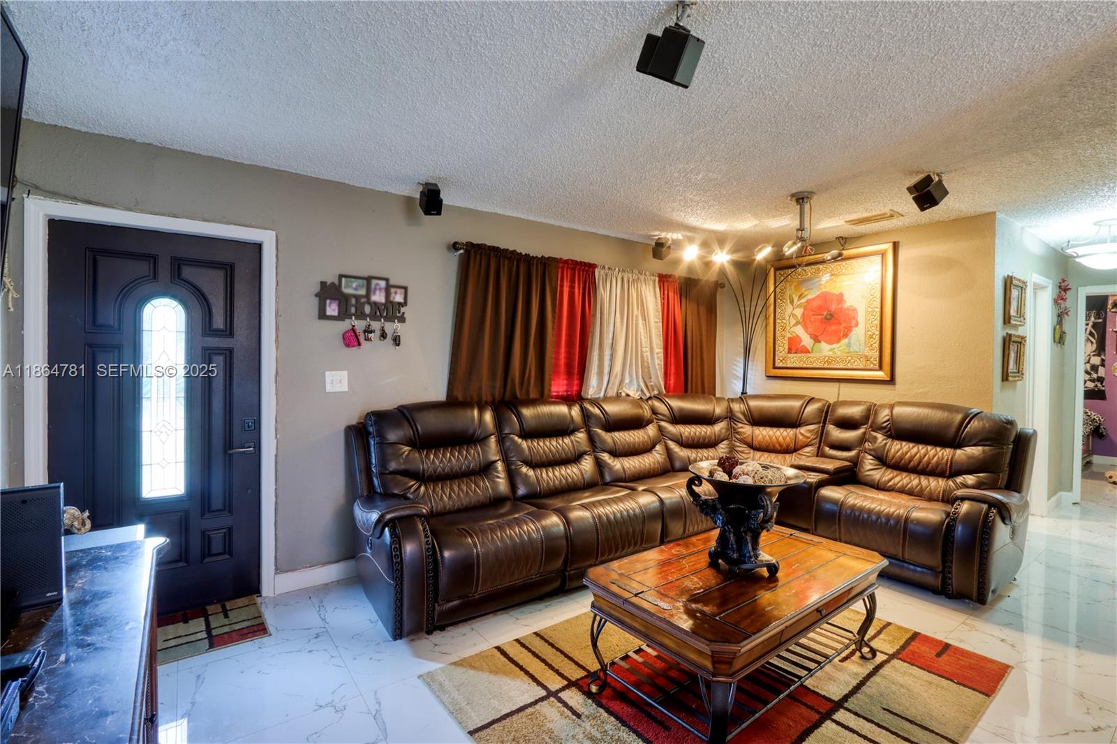 30211 Southwest 158th Road Homestead, FL 33033 - Photo 25 of 47 a living room with furniture a rug and a chandelier