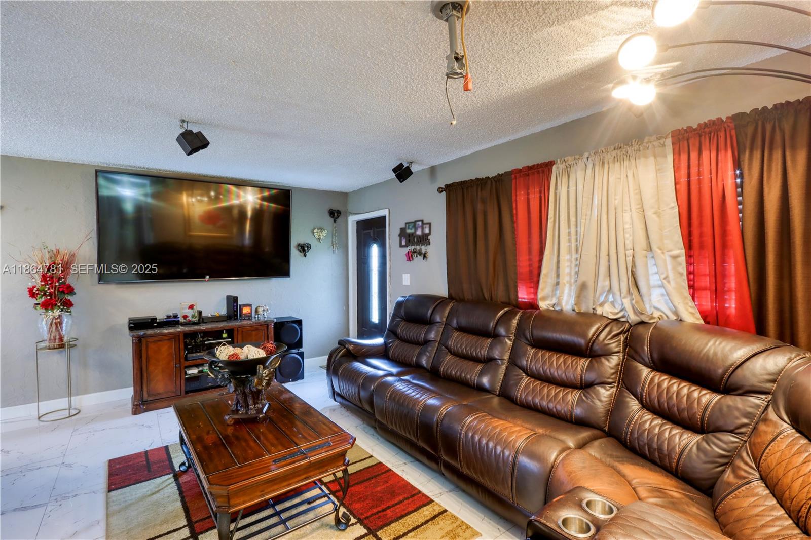 30211 Southwest 158th Road Homestead, FL 33033 - Photo 27 of 47 a living room with furniture and a flat screen tv