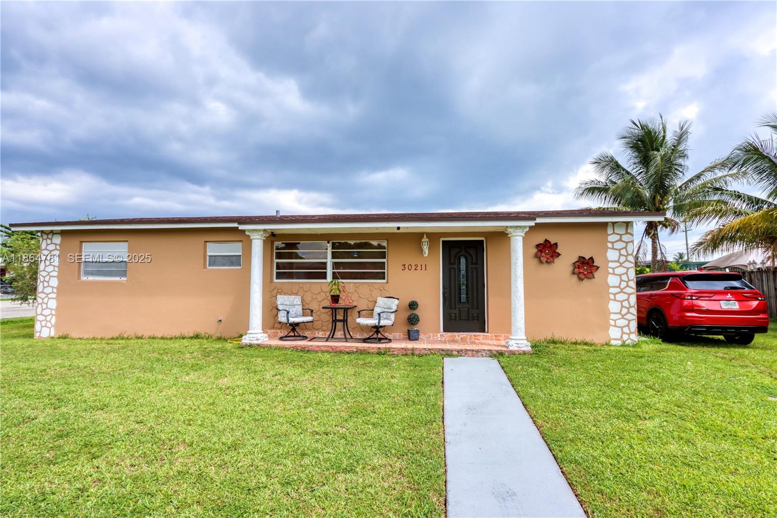 30211 Southwest 158th Road Homestead, FL 33033 - Photo 3 of 47 a front view of house with yard and outdoor seating