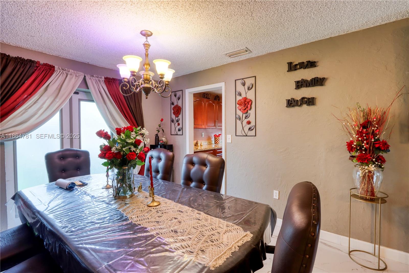 30211 Southwest 158th Road Homestead, FL 33033 - Photo 31 of 47 a view of a dining room with furniture and chandelier