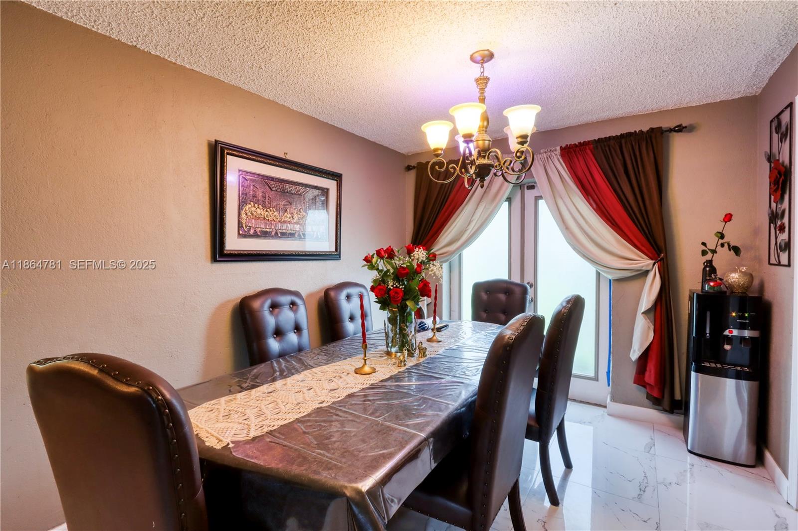 30211 Southwest 158th Road Homestead, FL 33033 - Photo 32 of 47 a view of a dining room with furniture and chandelier