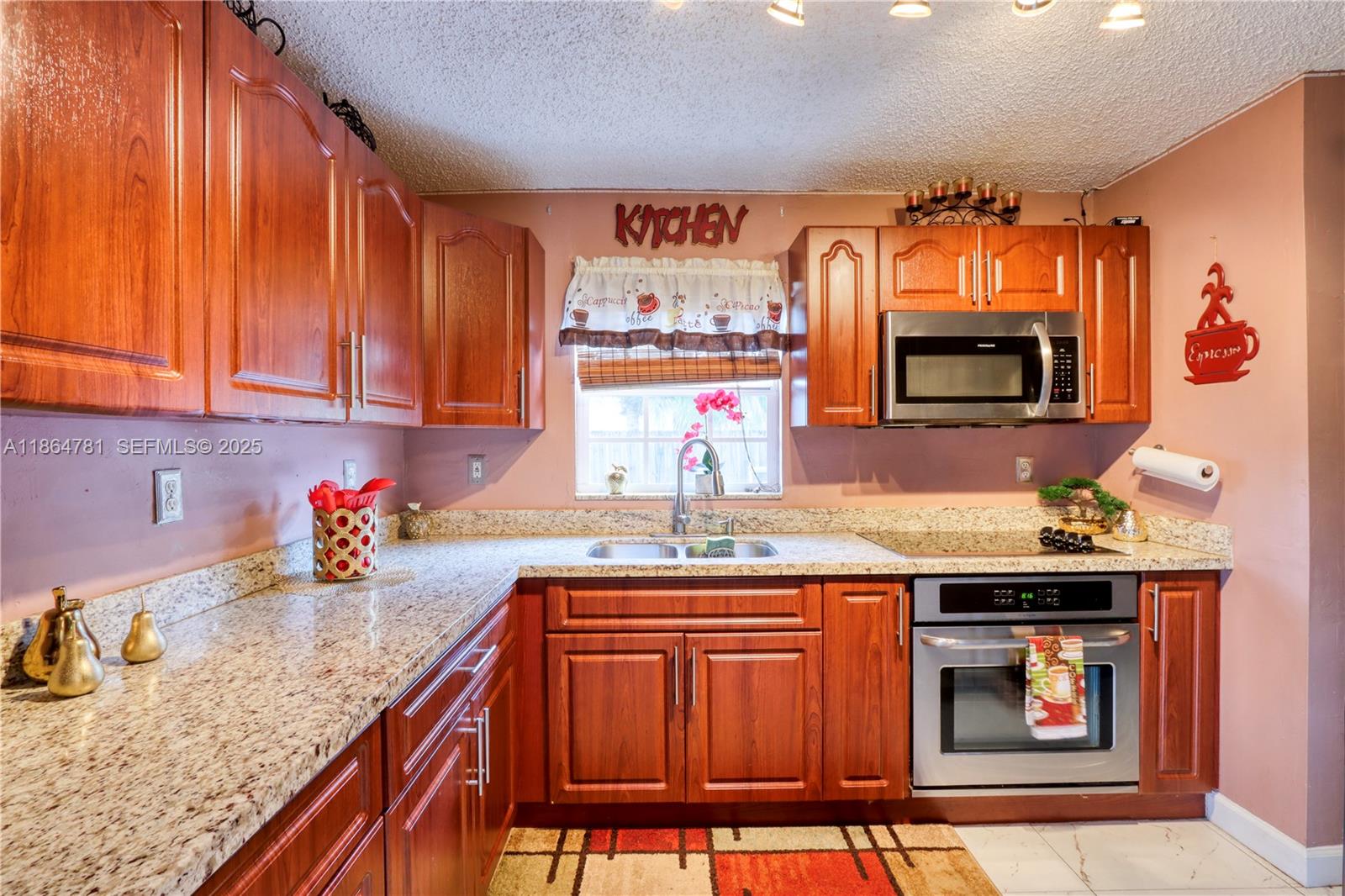 30211 Southwest 158th Road Homestead, FL 33033 - Photo 33 of 47 a kitchen with stainless steel appliances granite countertop a sink stove and cabinets