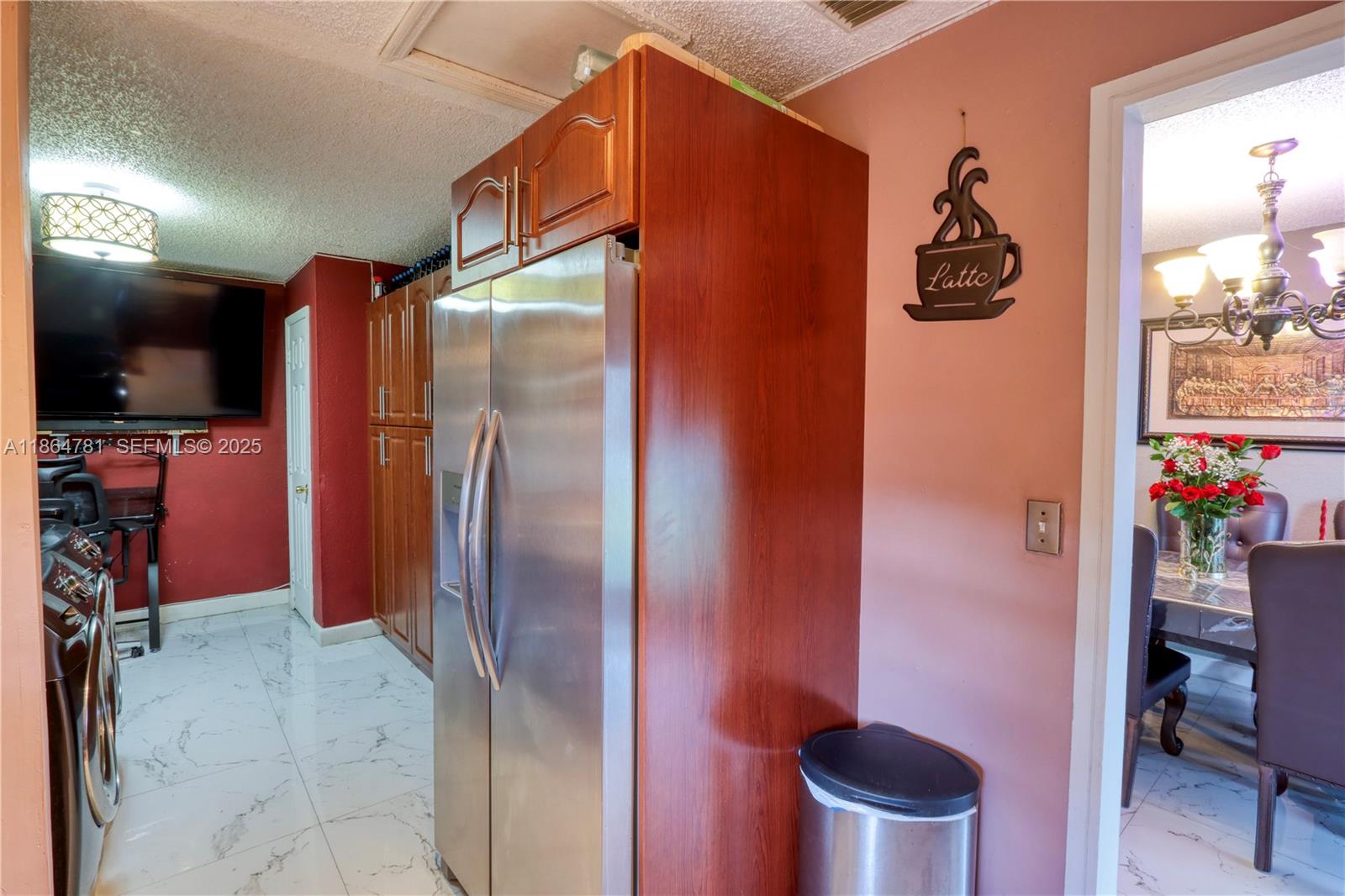 30211 Southwest 158th Road Homestead, FL 33033 - Photo 37 of 47 a kitchen with a refrigerator and a table