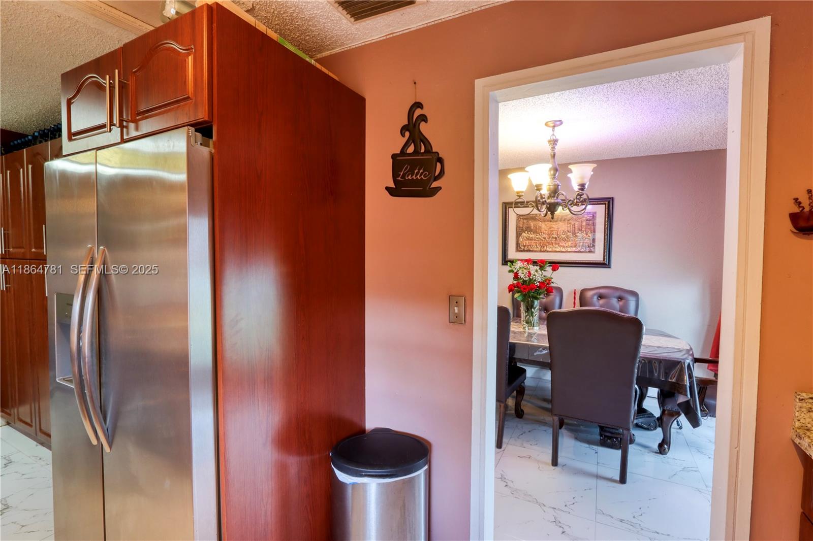 30211 Southwest 158th Road Homestead, FL 33033 - Photo 39 of 47 a kitchen with a refrigerator and chair