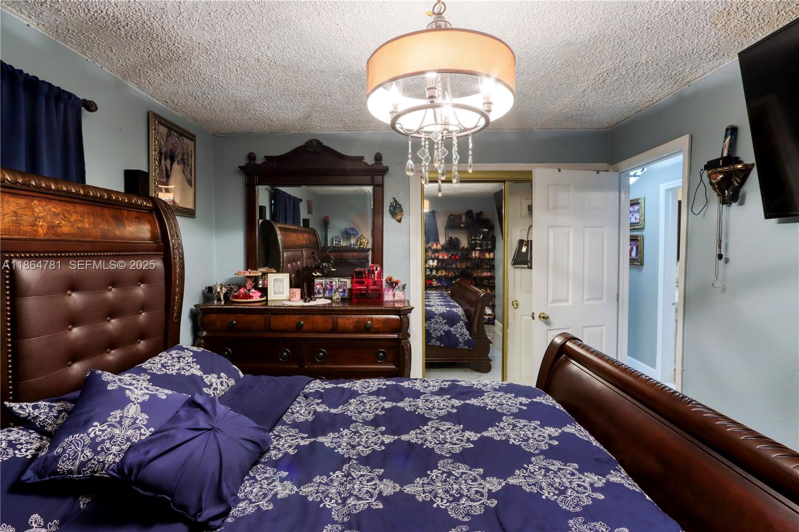 30211 Southwest 158th Road Homestead, FL 33033 - Photo 42 of 47 a living room with a couch and a chandelier