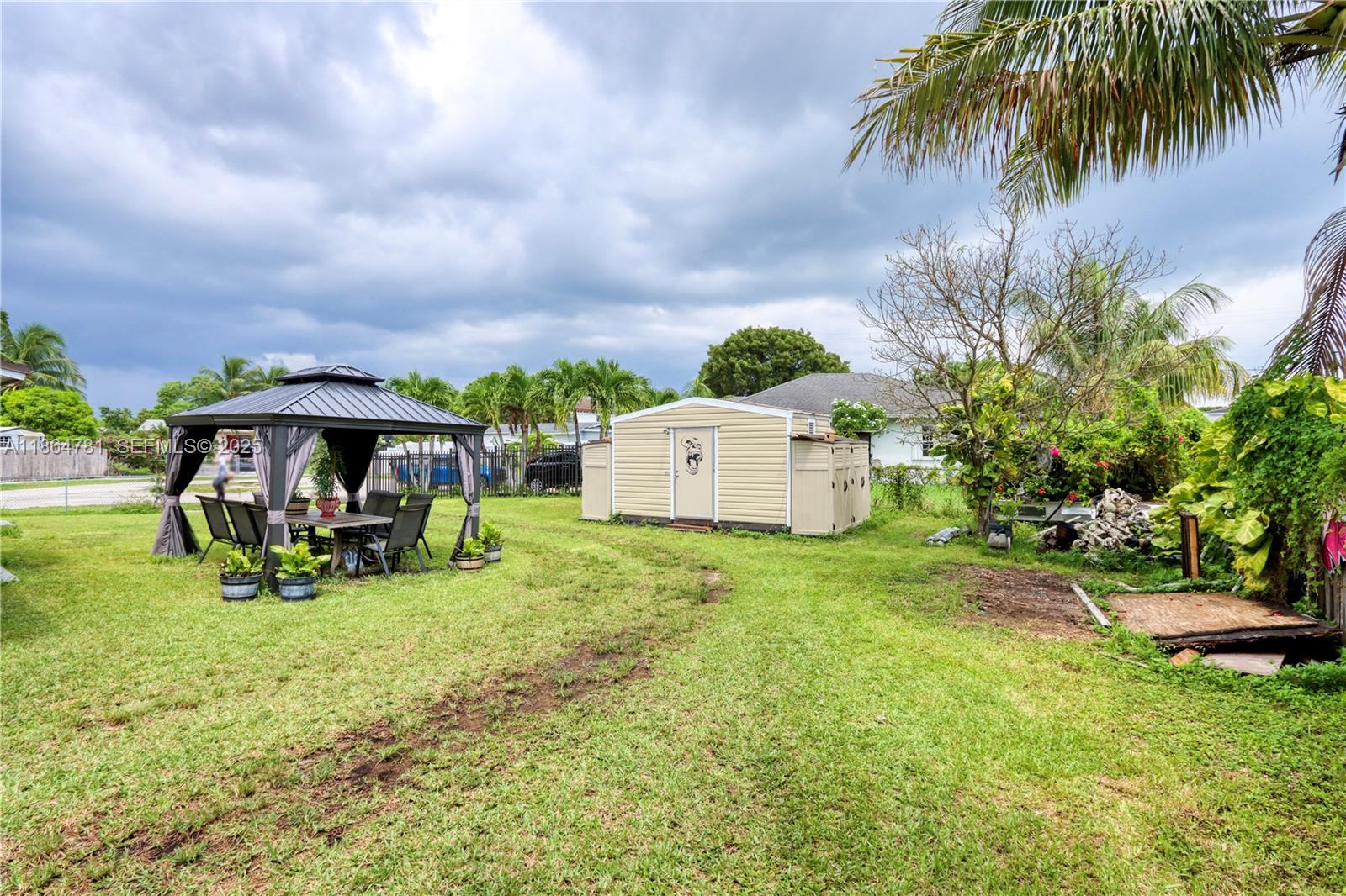 30211 Southwest 158th Road Homestead, FL 33033 - Photo 9 of 47 a view of a house with a yard and sitting area