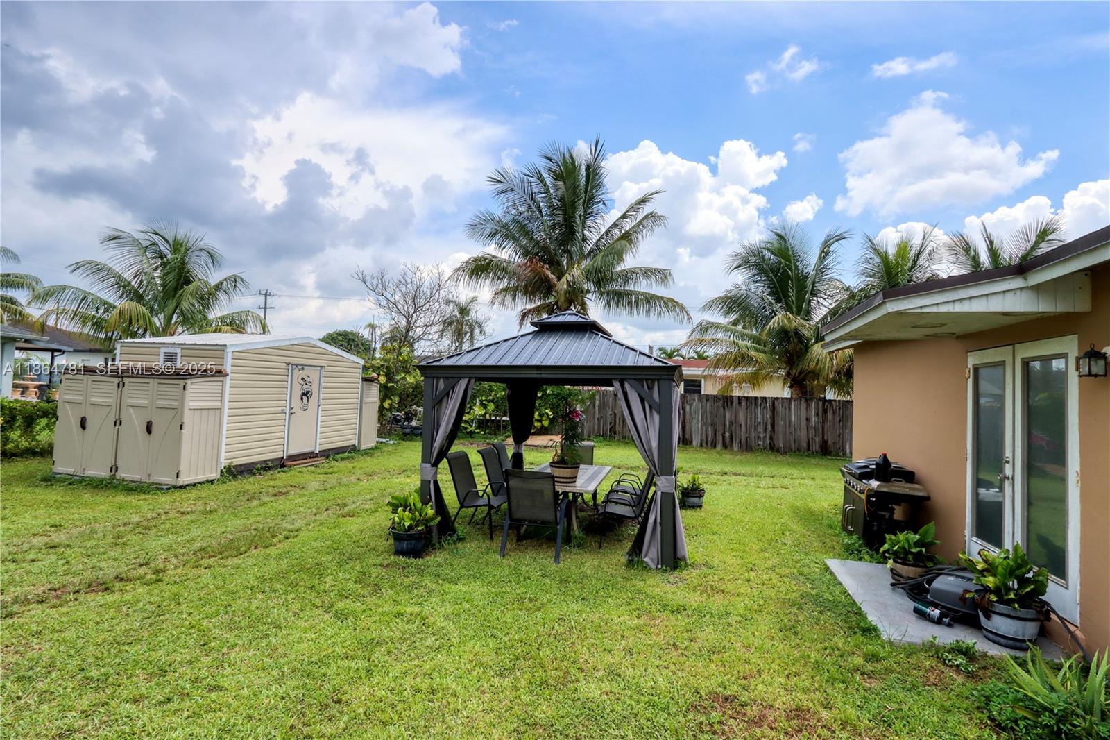 30211 Southwest 158th Road Homestead, FL 33033 - Photo 10 of 47 a view of backyard with barbeque grill and outdoor seating