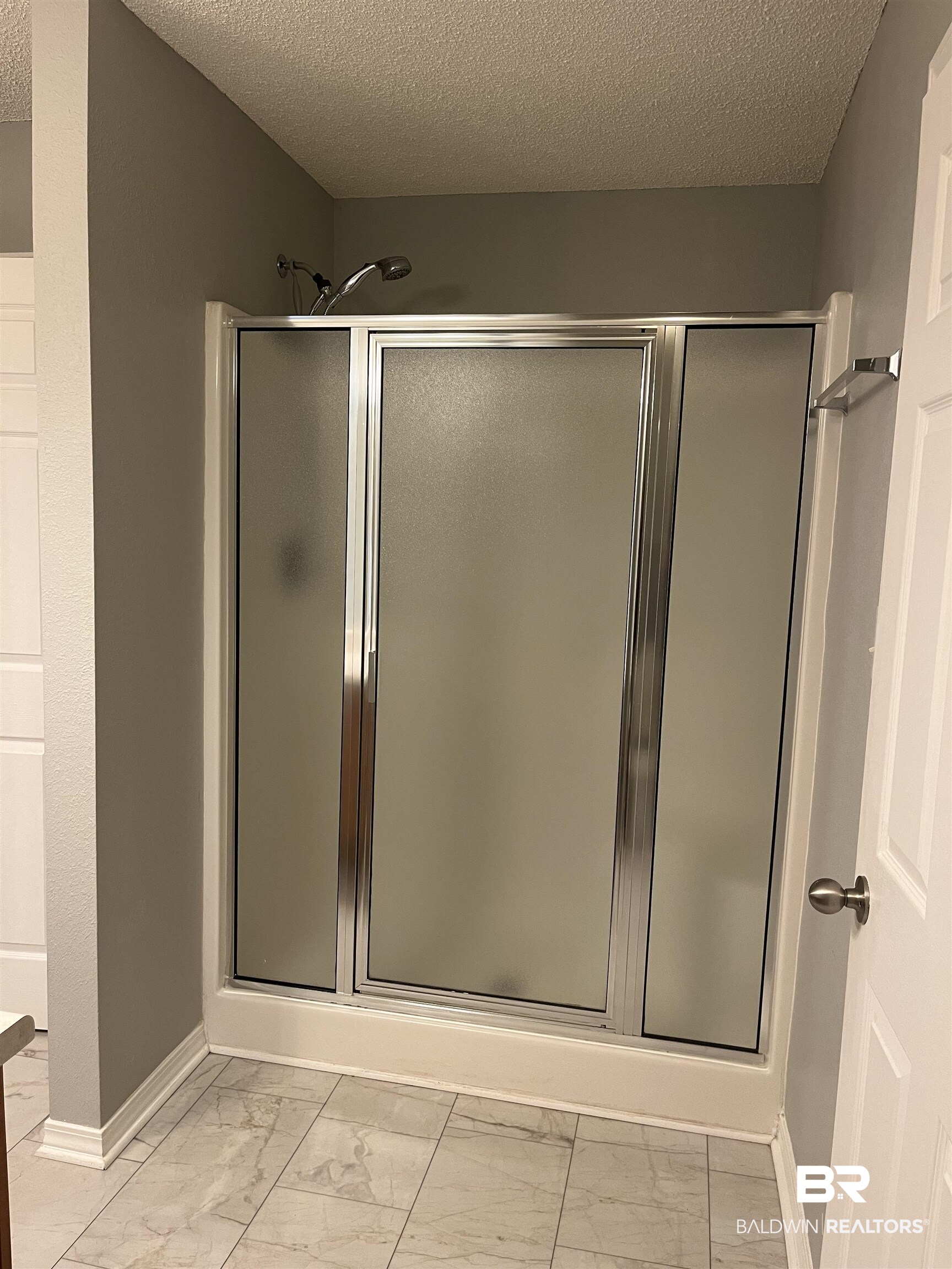 309 Cluster Street Foley, AL 36535 - Photo 16 of 38 Enclosed shower with frosted glass doors and chrome hardware