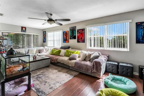 a living room with furniture ceiling fan and a rug
