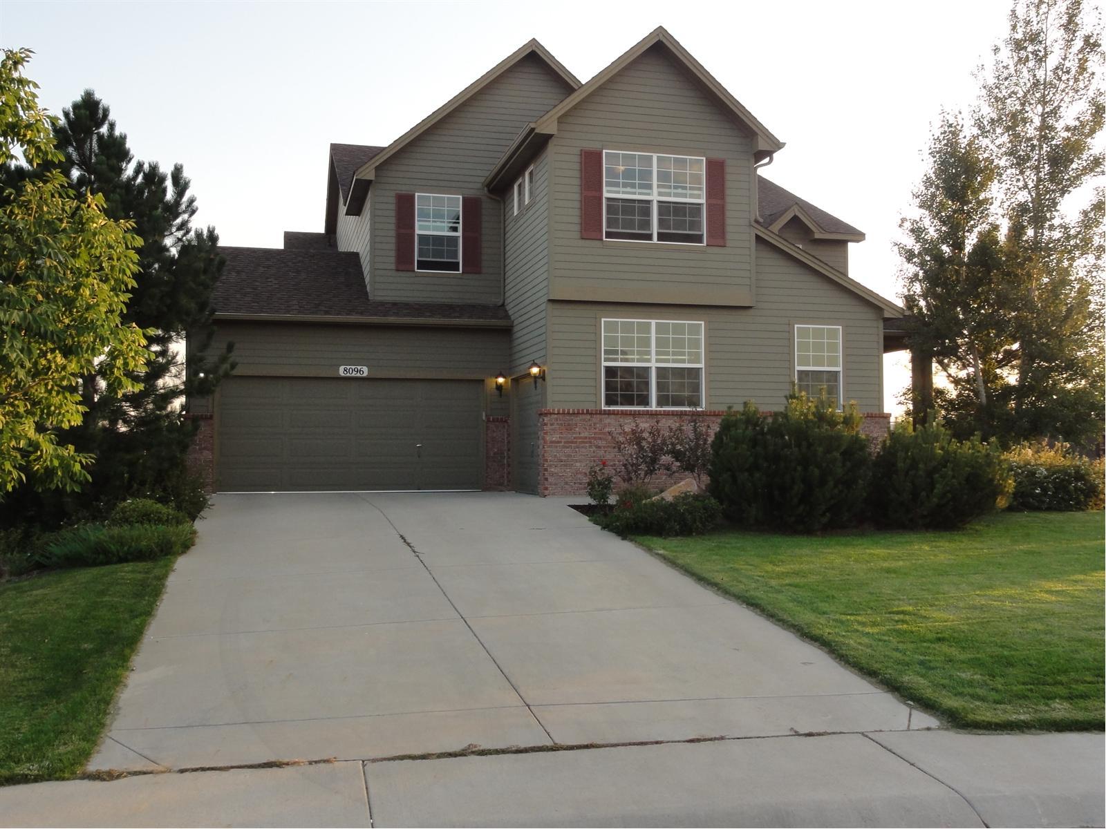 8096 Raspberry Drive Frederick, CO 80504 - Photo 1 of 1 a front view of a house with a yard and a garage