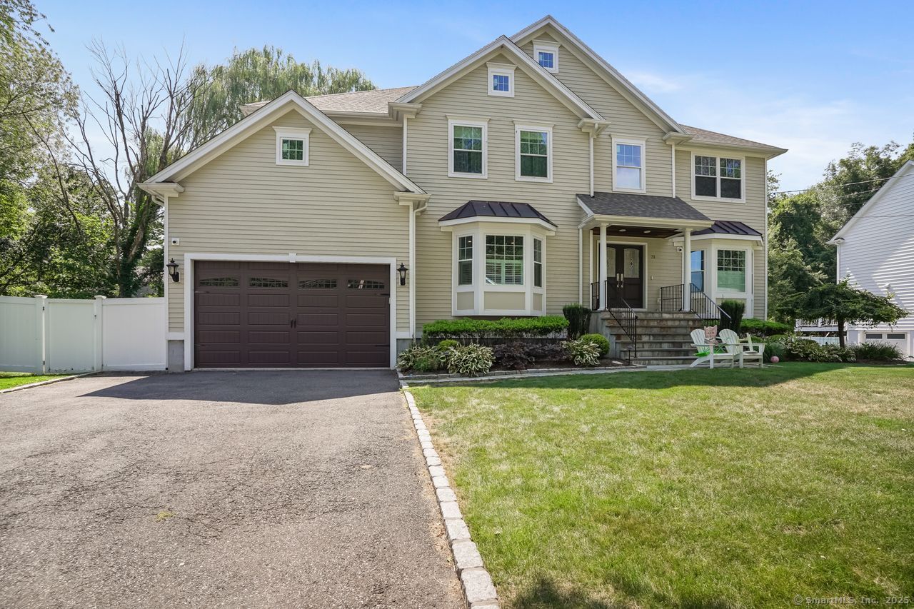 73 Marian Road Fairfield, CT 06825 - Photo 1 of 1 a front view of a house with a yard and garage
