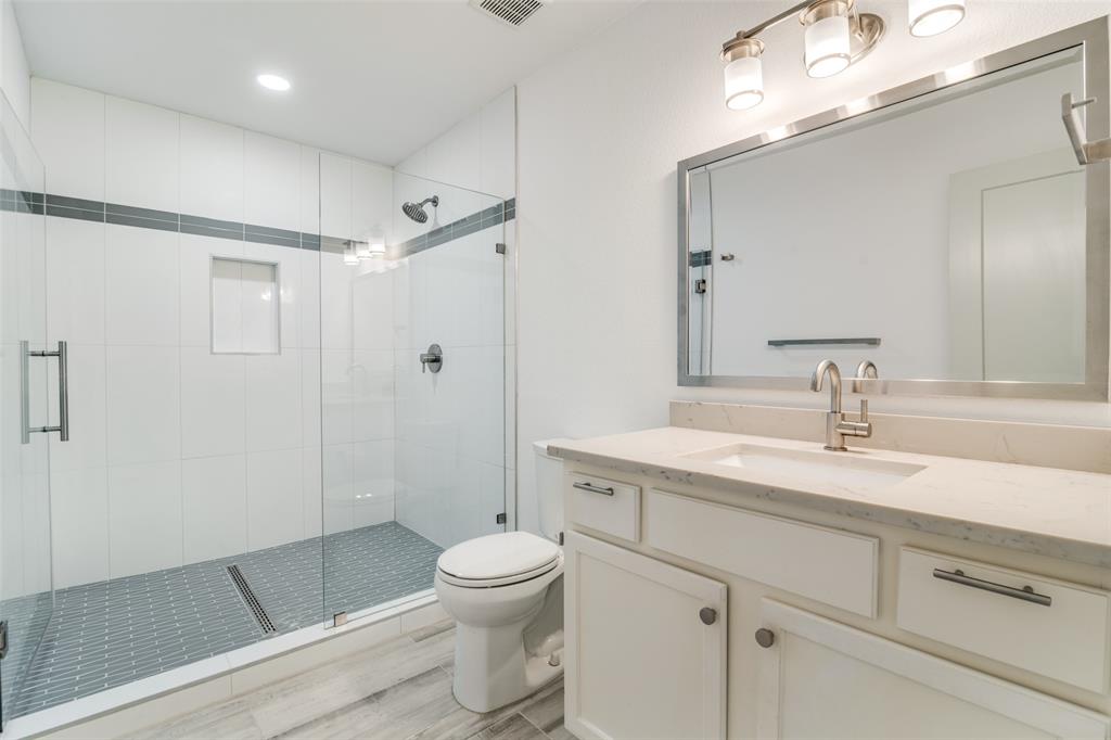 8722 Angora Street Dallas, TX 75218 - Photo 15 of 26 a bathroom with a sink a toilet and shower