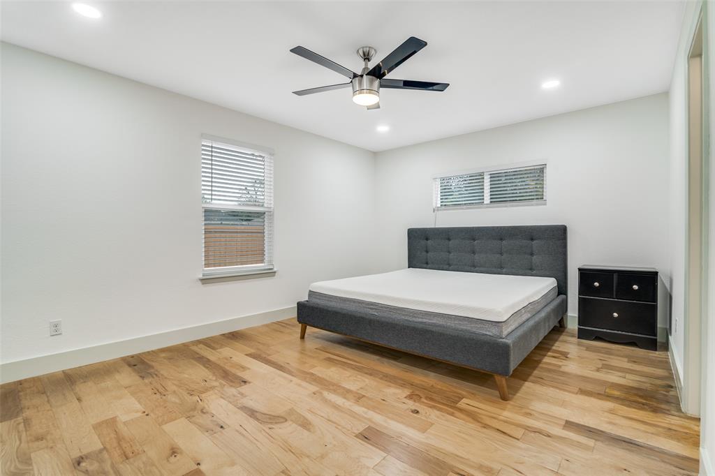 8722 Angora Street Dallas, TX 75218 - Photo 16 of 26 a spacious bedroom with a bed and window