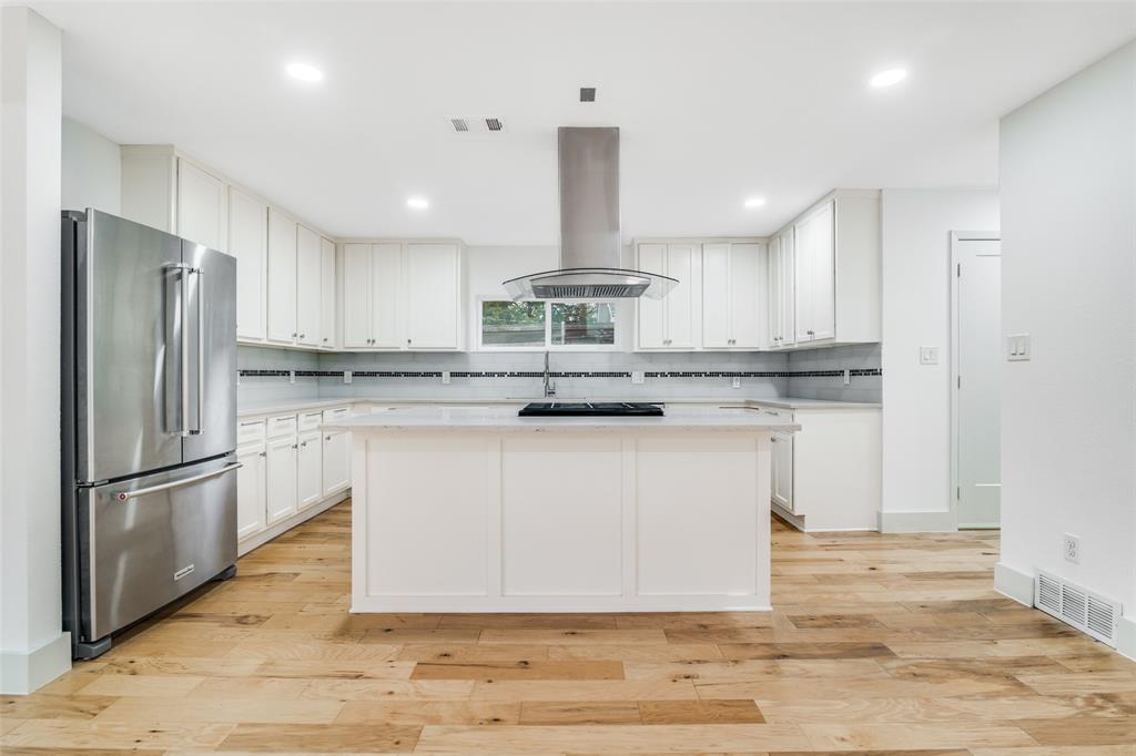 8722 Angora Street Dallas, TX 75218 - Photo 2 of 26 a kitchen with stainless steel appliances granite countertop a refrigerator a stove and a sink