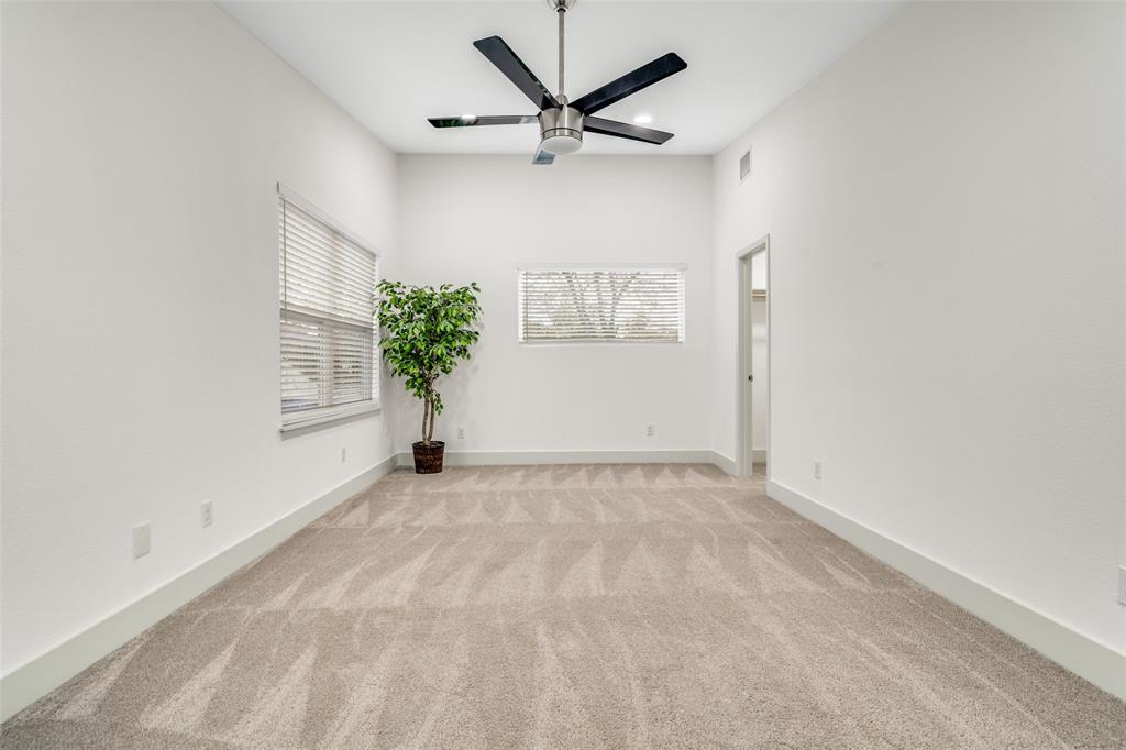 8722 Angora Street Dallas, TX 75218 - Photo 21 of 26 an empty room with potted plant and a ceiling fan