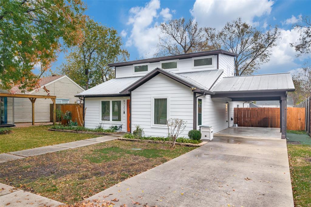 8722 Angora Street Dallas, TX 75218 - Photo 4 of 26 a front view of a house with a yard and garage