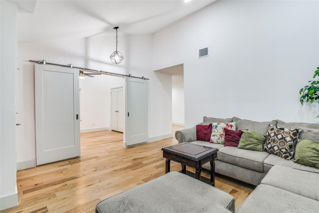 8722 Angora Street Dallas, TX 75218 - Photo 6 of 26 a living room with furniture and a wooden floor