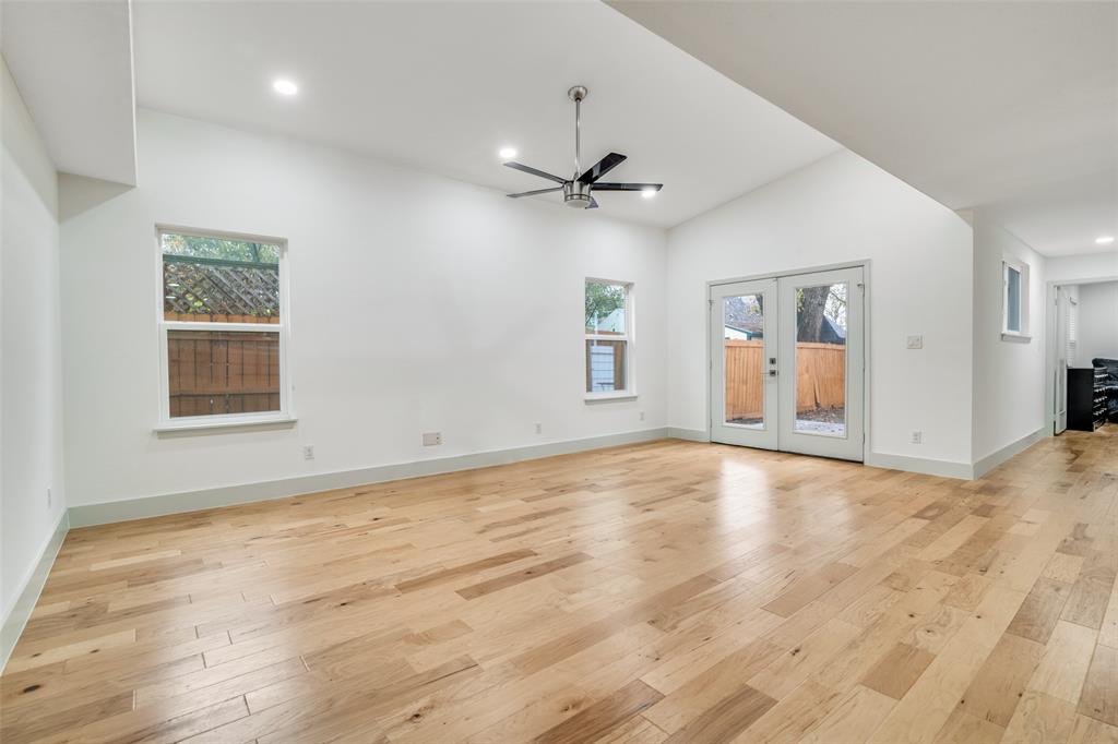 8722 Angora Street Dallas, TX 75218 - Photo 7 of 26 wooden floor in an empty room with a window