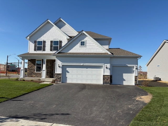 102 Ellis Road Algonquin, IL 60102 - Photo 1 of 45 a front view of a house with a yard and garage