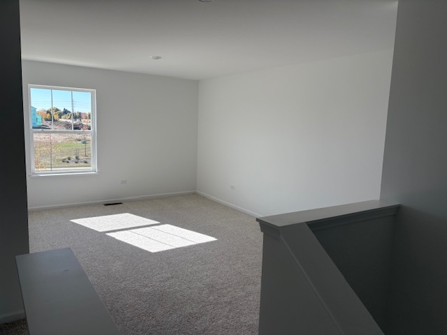 102 Ellis Road Algonquin, IL 60102 - Photo 6 of 45 a view of an empty room with a window