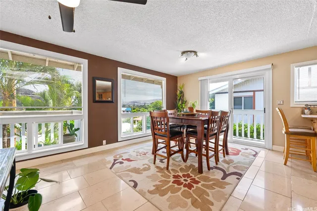 a dining room with furniture a large window and a rug
