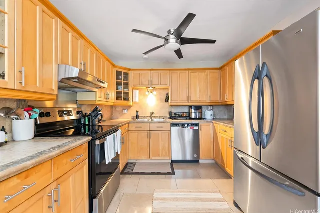a kitchen with a stove a sink and a refrigerator