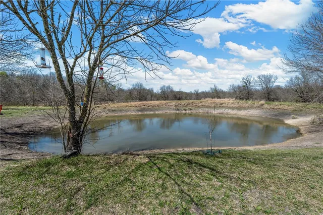 a view of a backyard with table and chairs and a fire pit