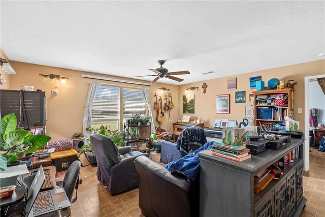 a living room with furniture and a bookshelf