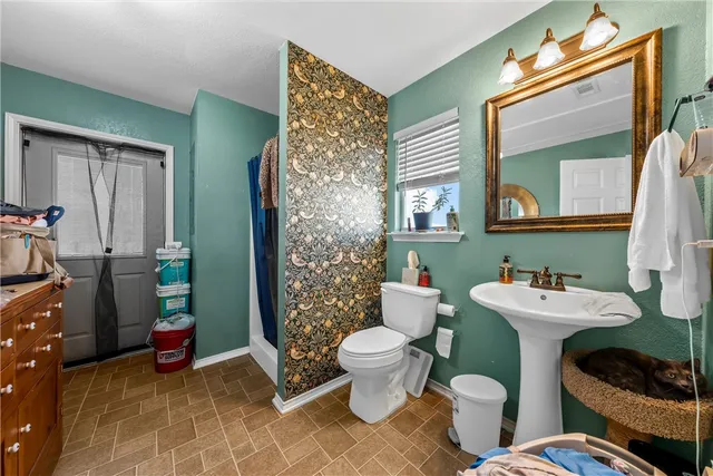 a bathroom with a sink mirror vanity and toilet