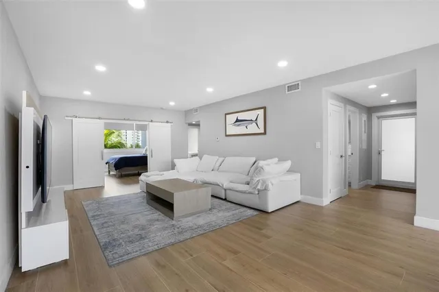 a bedroom with a large bed and flat screen tv