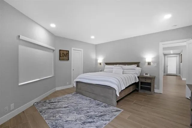 a bedroom with a bed and a painting on the wall