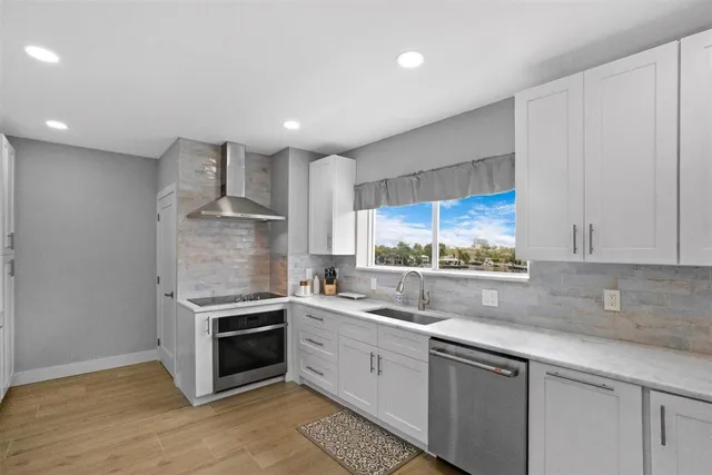 a view of a lake with boats and trees in the background