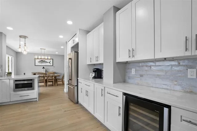 a view of a dining room with furniture wooden floor and chandelier