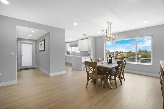 a bedroom with a large bed and painting on the wall