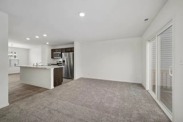 a large kitchen with a refrigerator and a sink