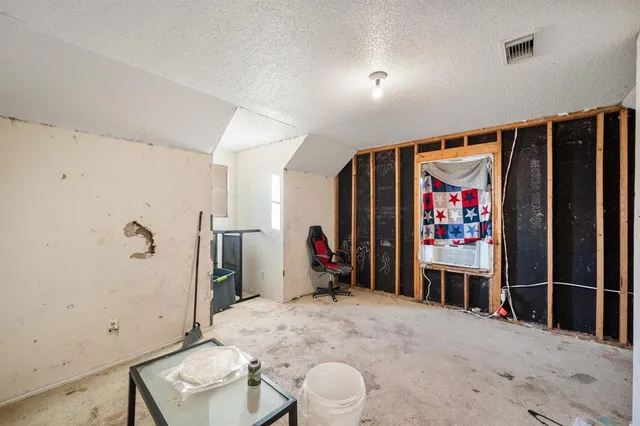 a view of a hallway with furniture and refrigerator