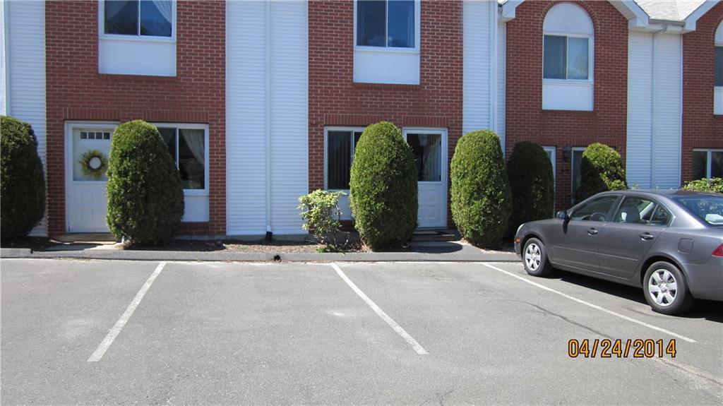 585 Park Road, Unit 810 Waterbury, CT 06708 - Photo 1 of 1 a car parked in front of a brick house