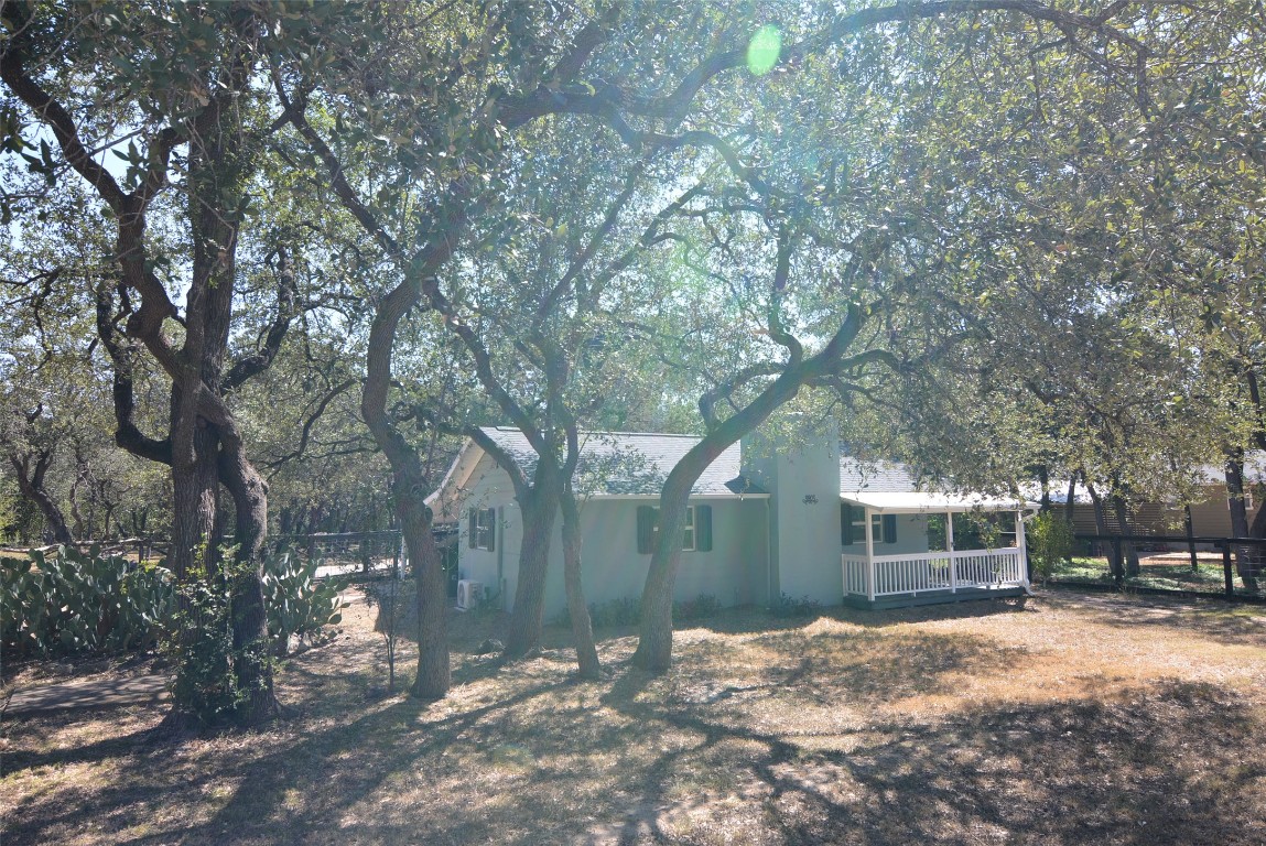 a backyard of a house with outdoor seating and trees