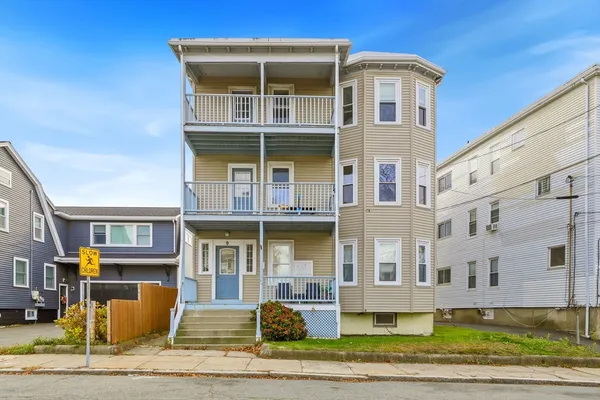 a front view of a residential apartment building with a yard