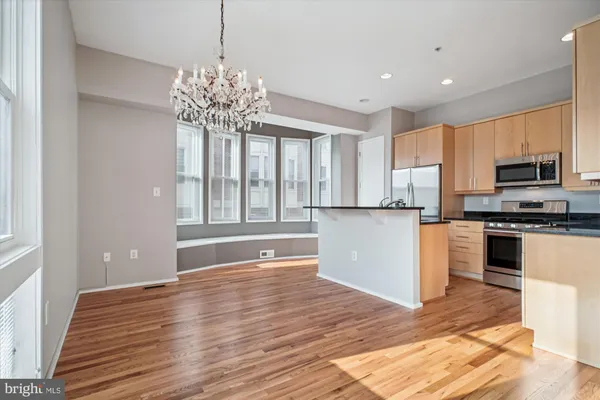 a view of a kitchen with microwave and cabinets