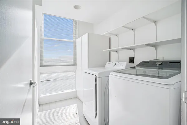 a utility room with cabinets washer and dryer