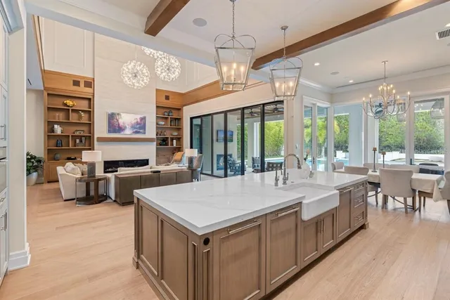 a kitchen with a table chairs and wooden floor