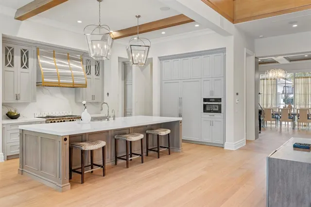 a kitchen with cabinets stainless steel appliances and a counter space