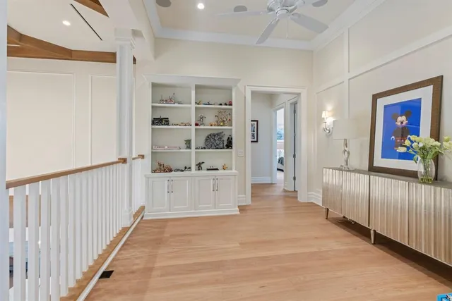 a spacious bedroom with a bed a window and a chandelier