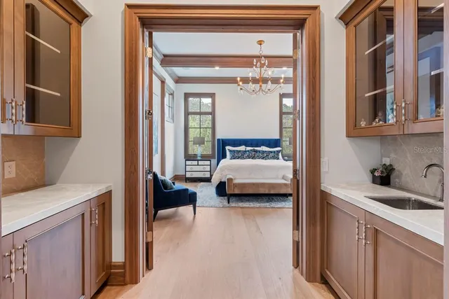 a spacious bedroom with a bed and a chandelier