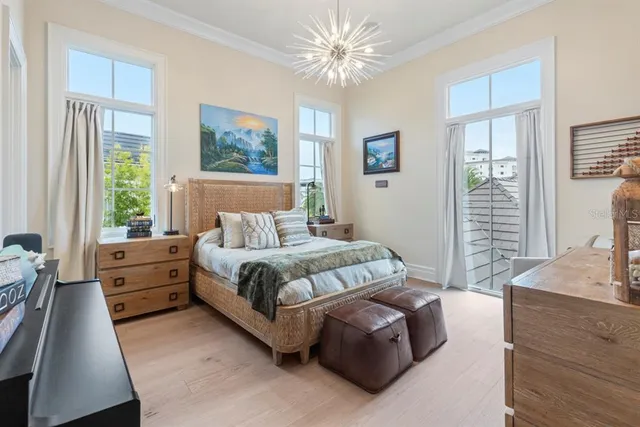 a living room with furniture a fireplace and floor to ceiling window