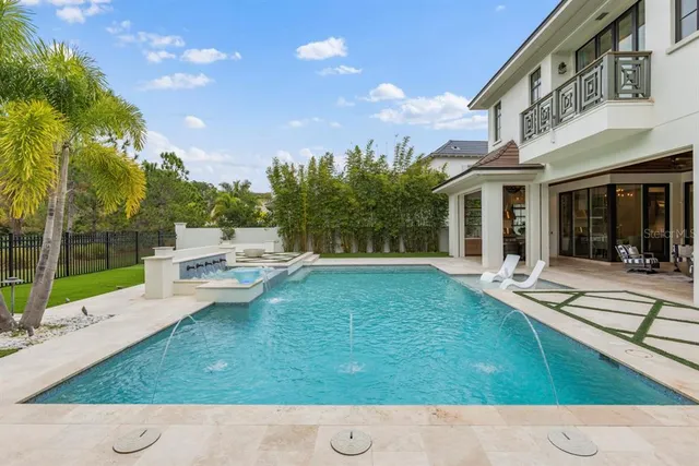 a view of a living room and floor to ceiling window with wooden floor