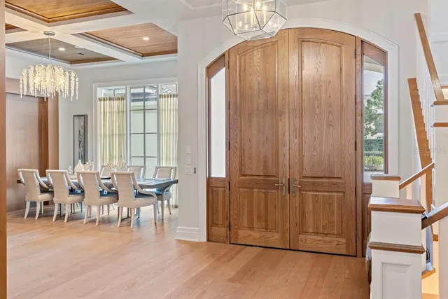 a living room with furniture or chandelier and a large window