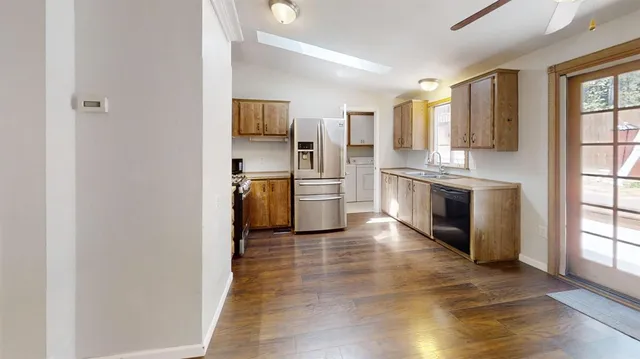 a kitchen with stainless steel appliances granite countertop a refrigerator and a stove top oven